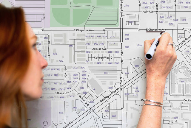 Woman writing on a custom dry erase street map